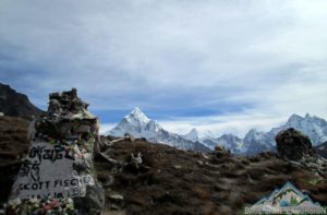 Travelers taking selfie with Scott Fischer memorial chhorten in Everest